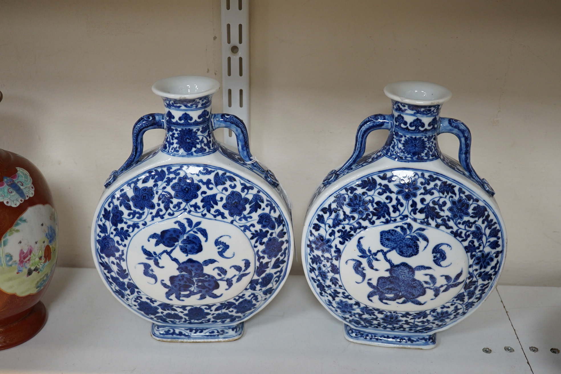 A near pair of Chinese blue and white moonflasks, bianhu, Daoguang seal marks and of the period (1821-50)